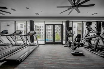 A gym with treadmills and elliptical machines.